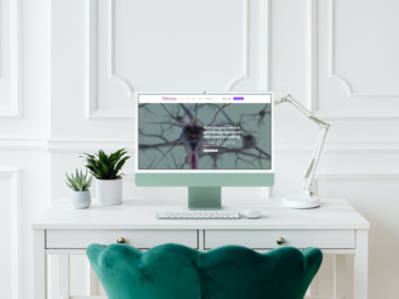 A computer screen with a green chair in front of it.